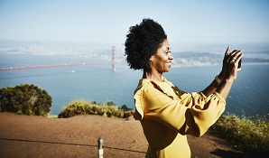 woman taking photos by golden gate bridge