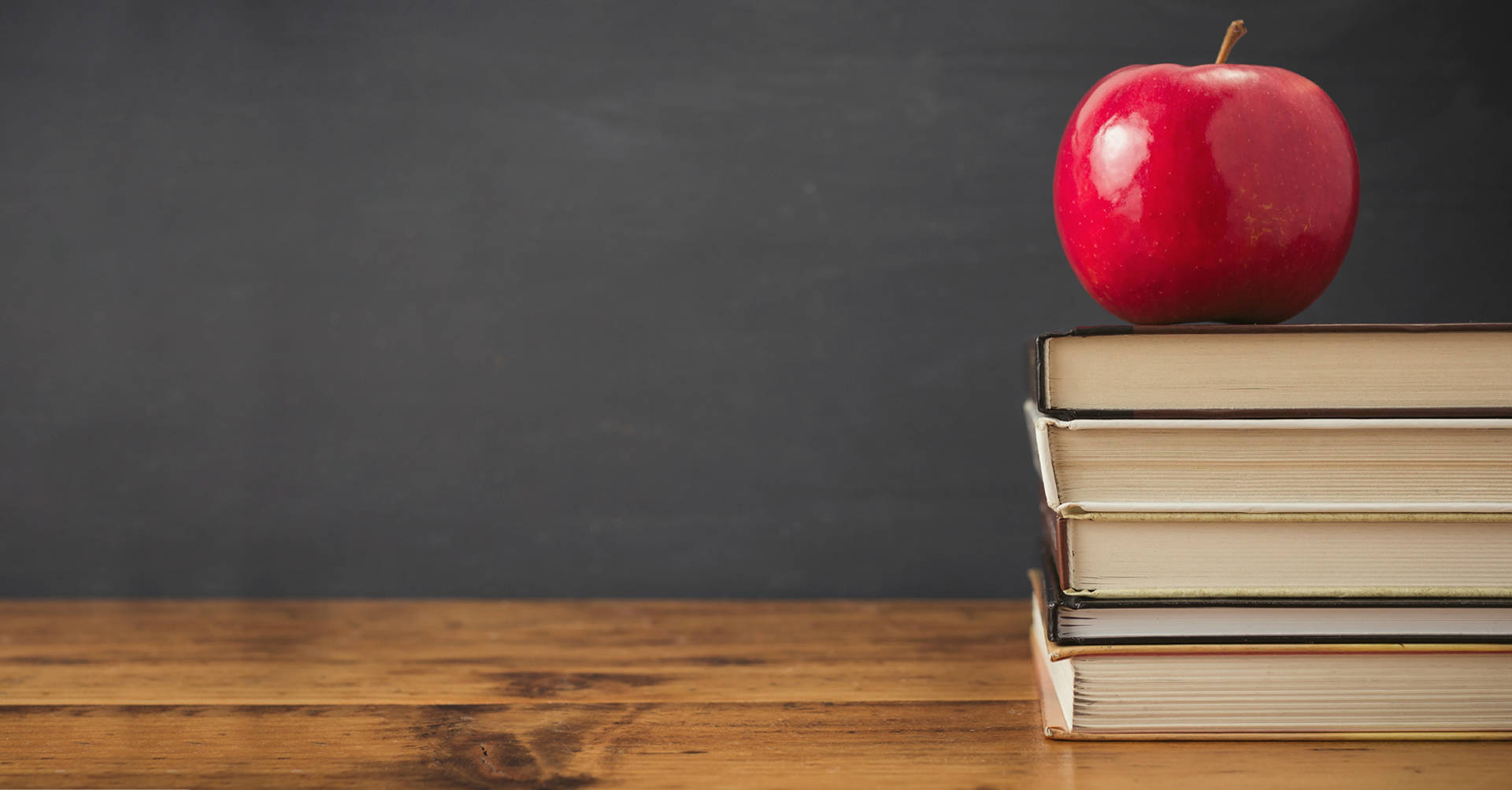 apple on books on desk