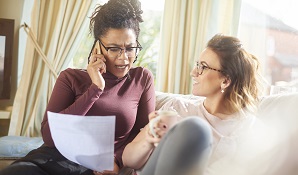 woman on the phone looking at document