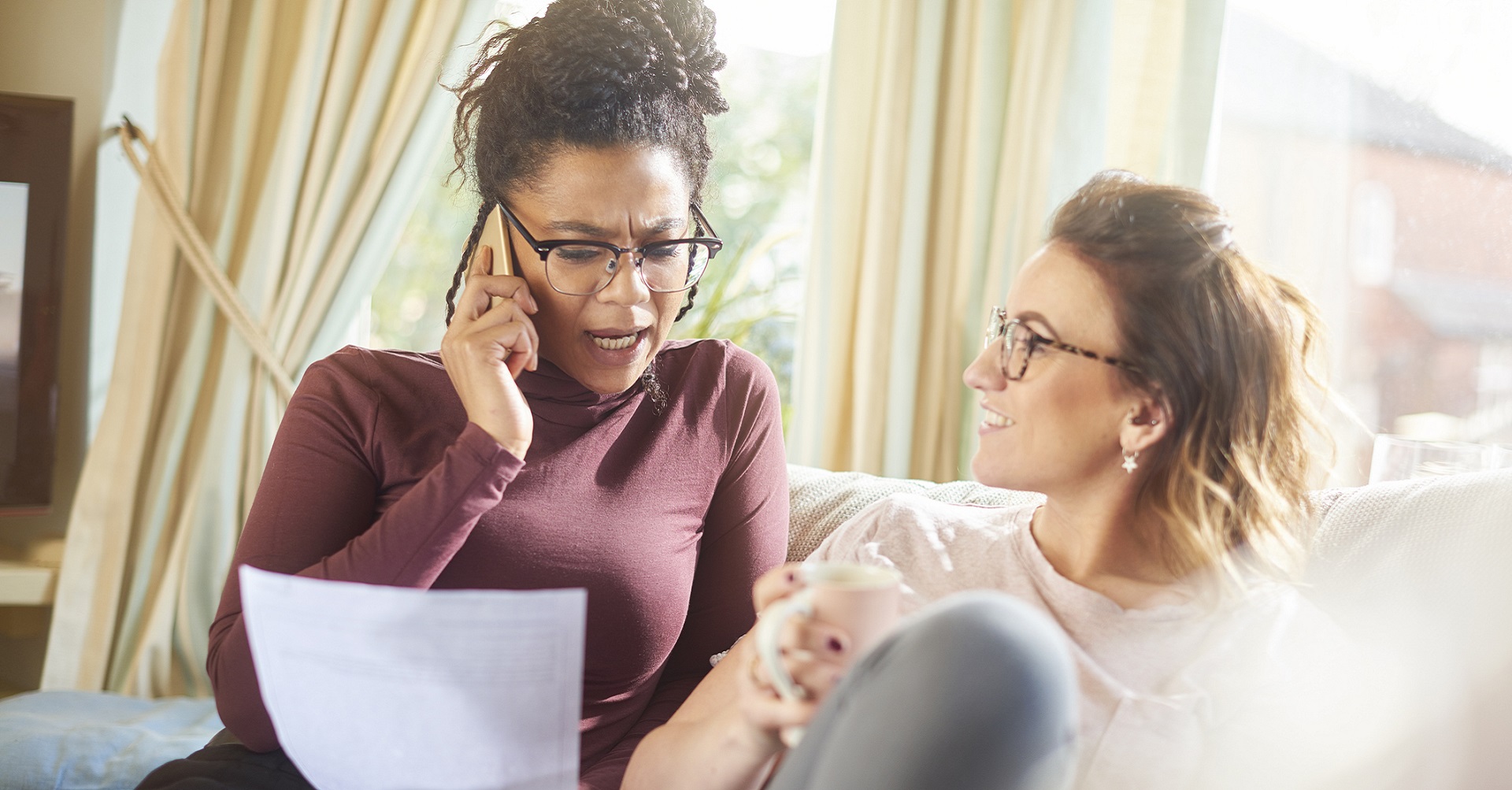 woman on the phone looking at document