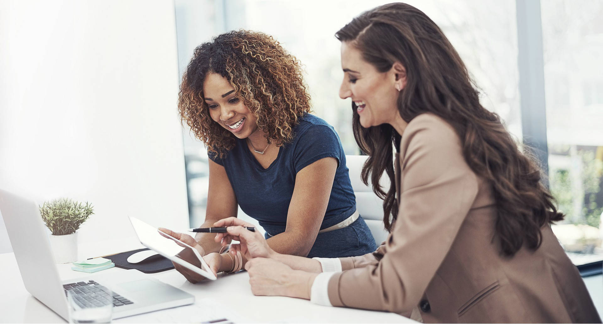 Two ladies looking at tablet