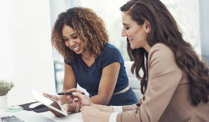 Two ladies looking at tablet