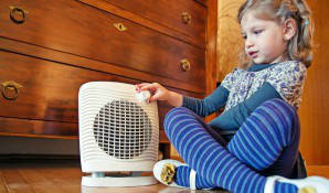 girl sitting with heater