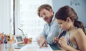 Father helping daughter with homework