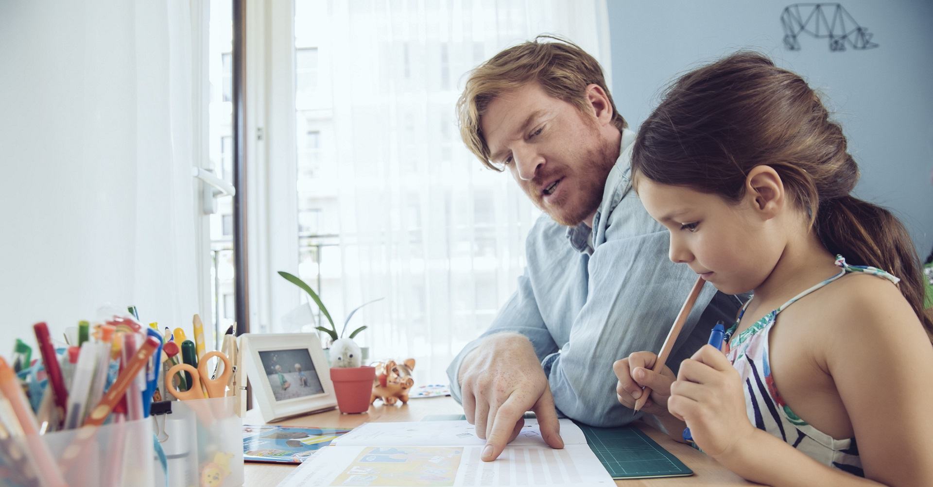 Father helping daughter with homework