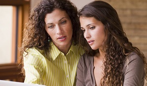 Mother and daughter looking at laptop