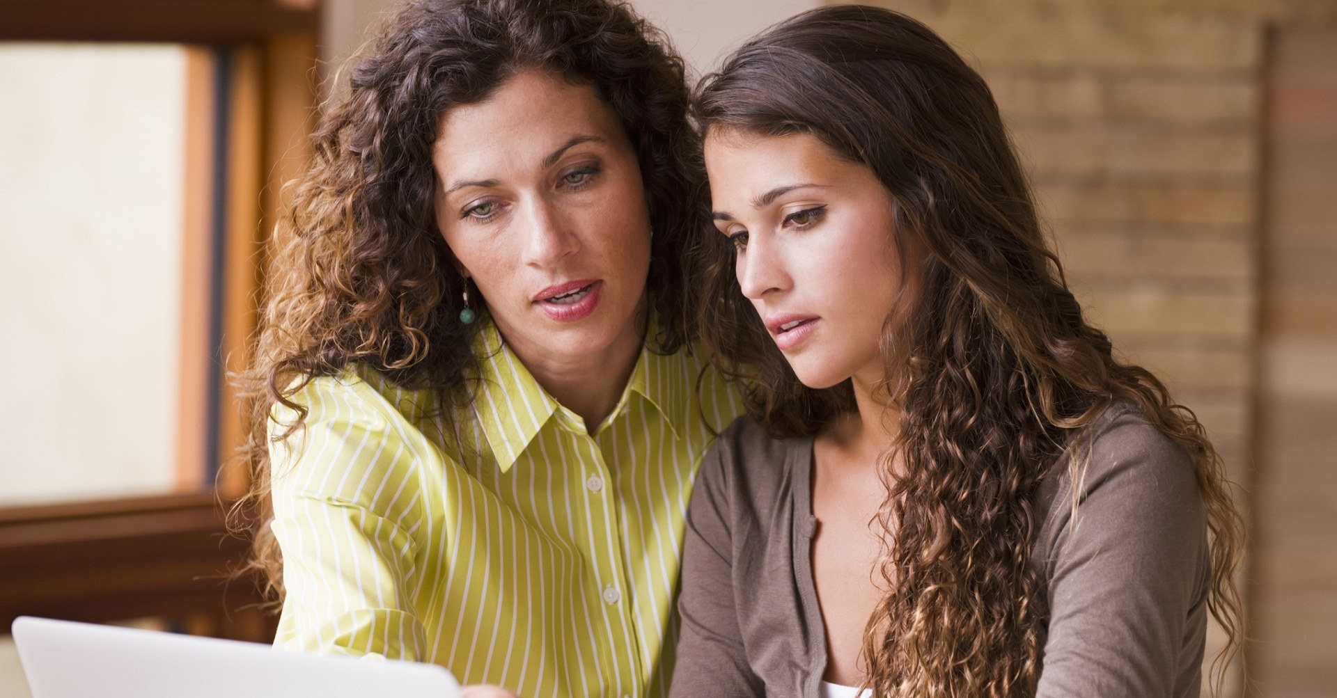 Mother and daughter looking at laptop