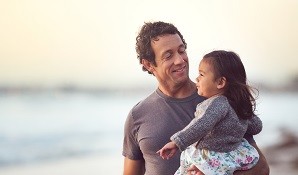 Dad with daughter on the beach