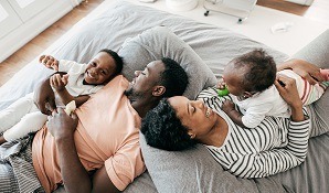 Happy family laying on bed