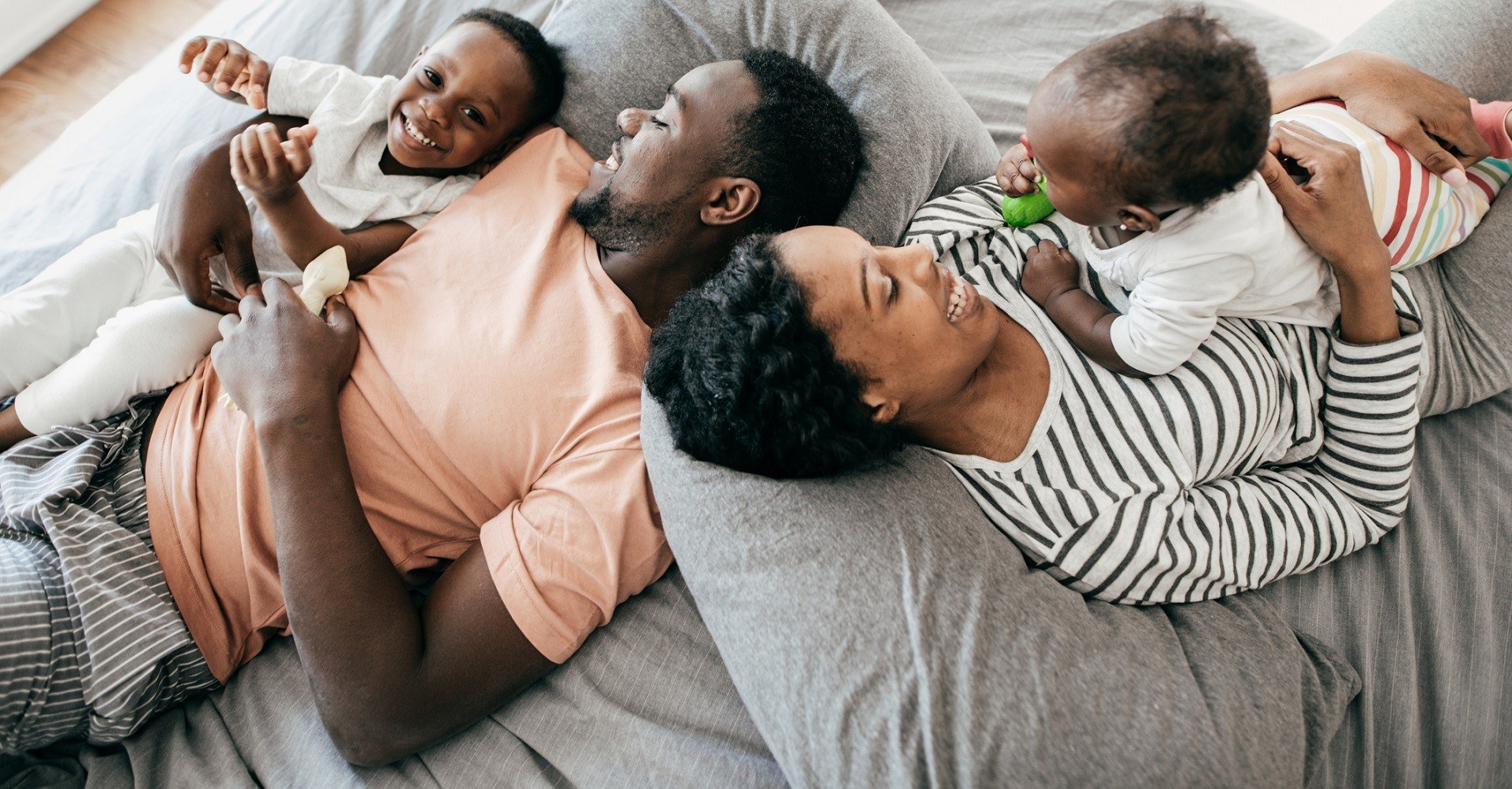 Happy family laying on bed