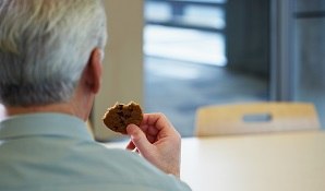 man eating biscuit