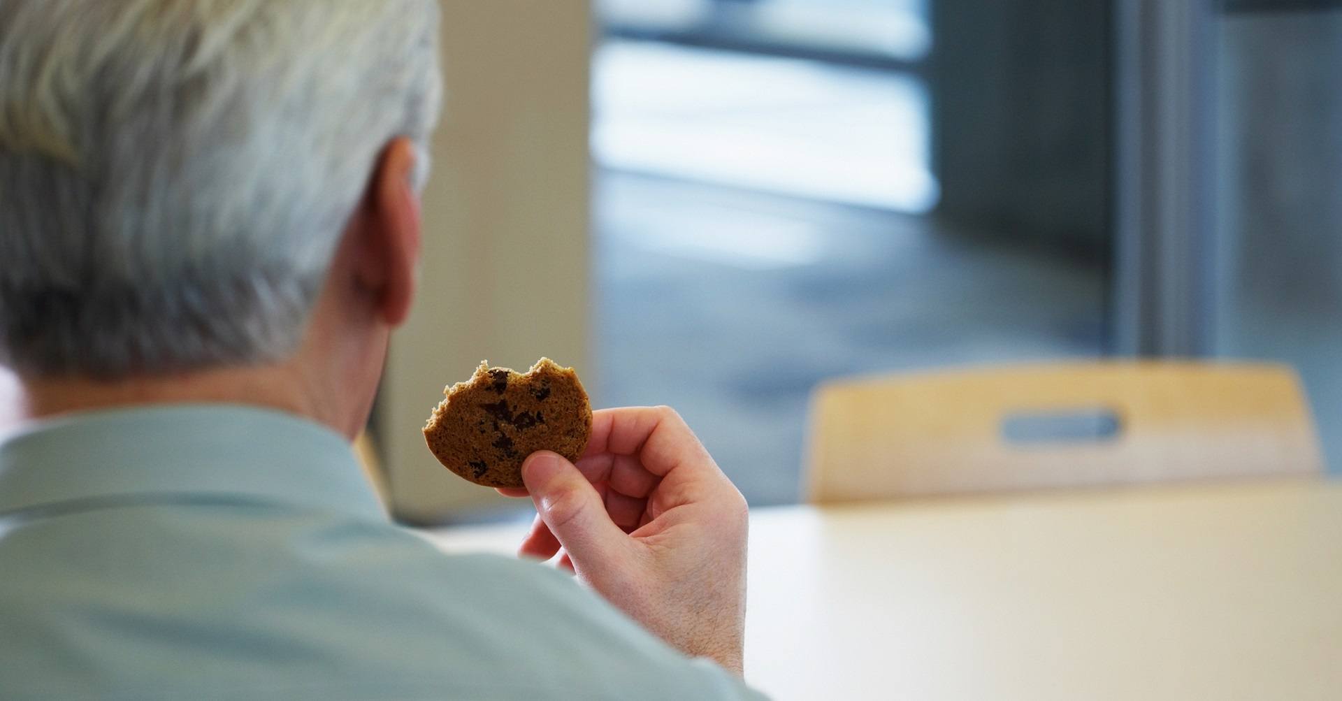 man eating biscuit