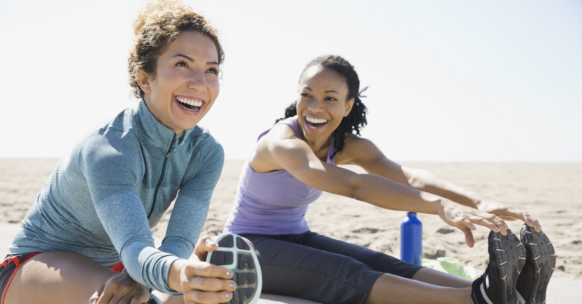 Women on beach stretching