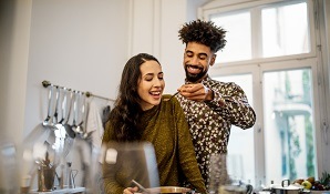 man feeding woman