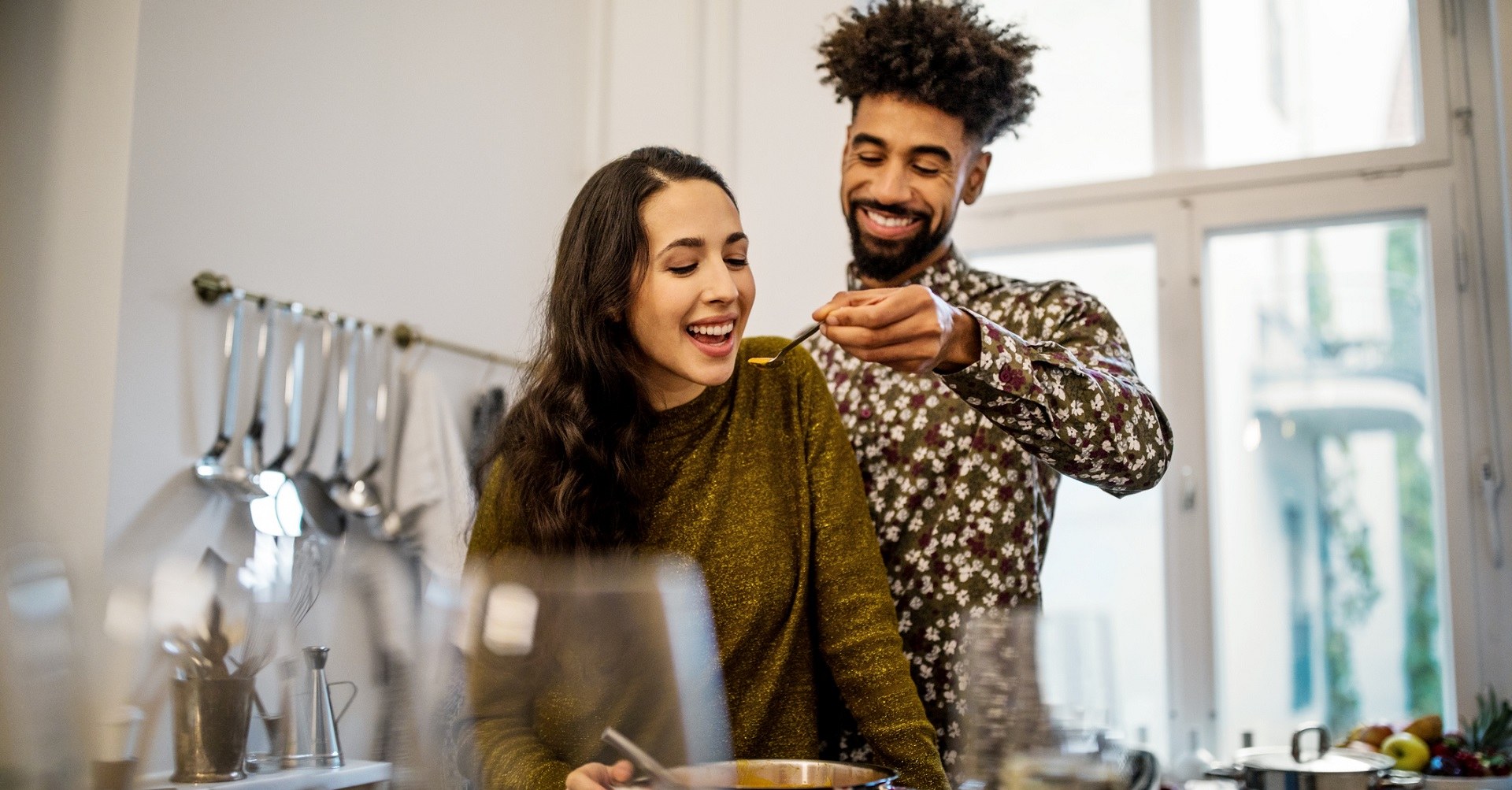 man feeding woman