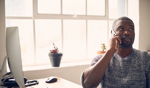 Man at desk on the phone