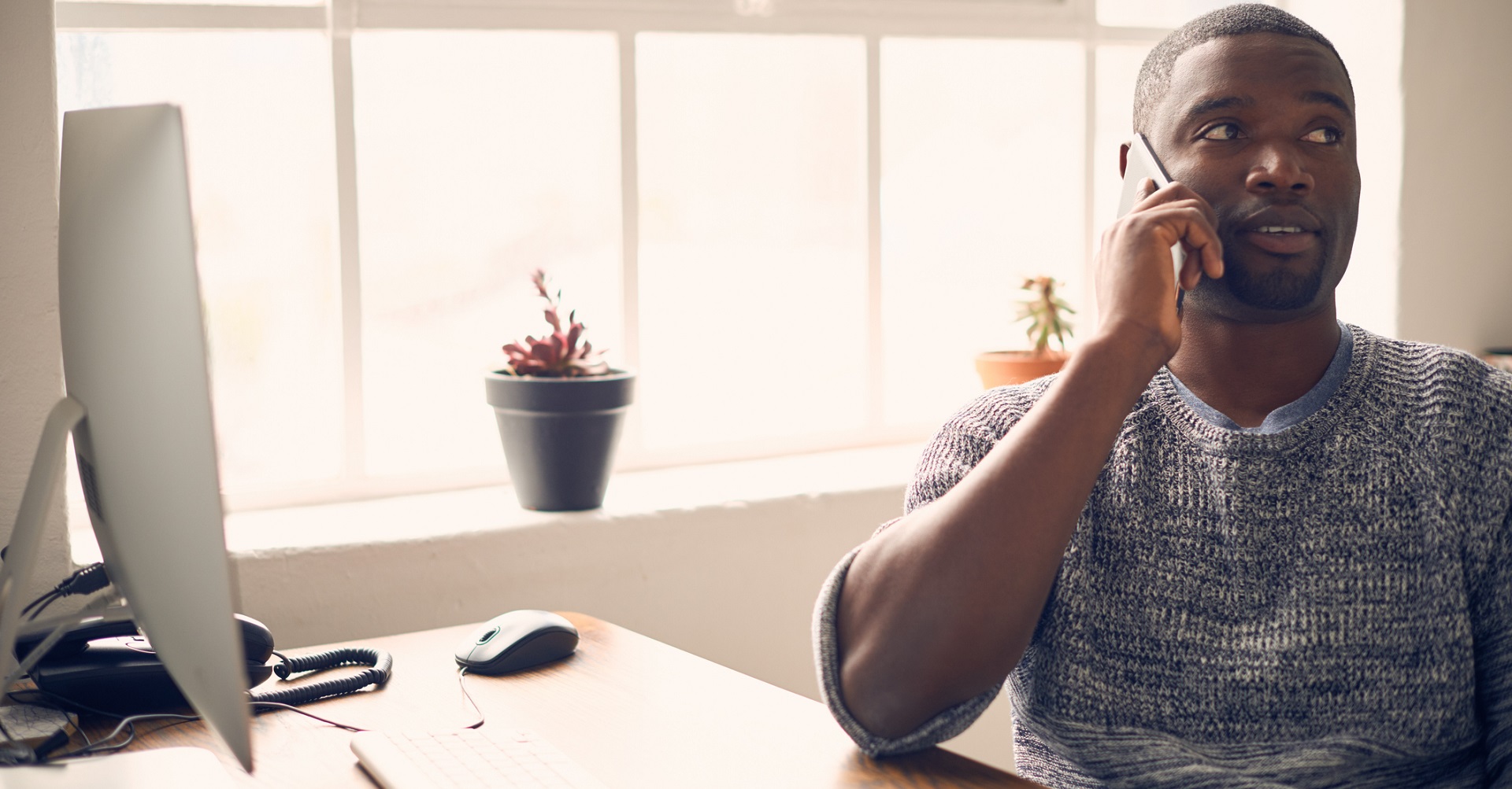 Man at desk on the phone