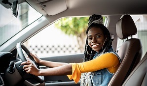 Young woman sitting in car