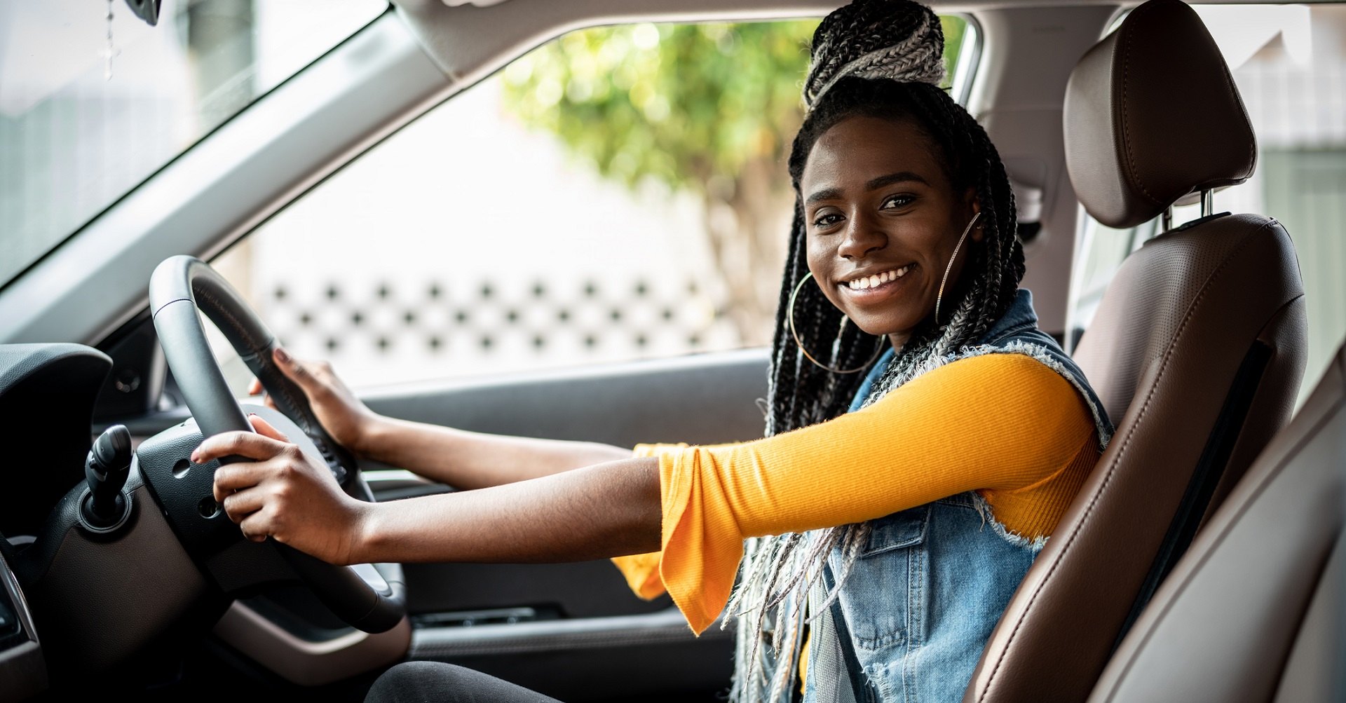 Young woman sitting in car