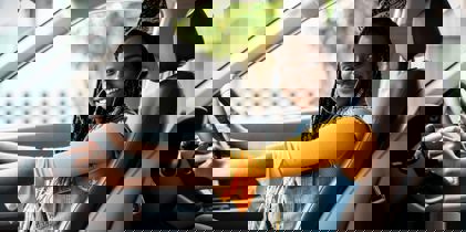 Young woman sitting in car