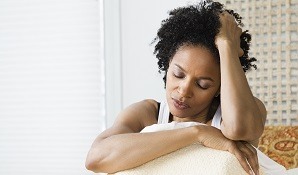 Stressed person sitting on bed