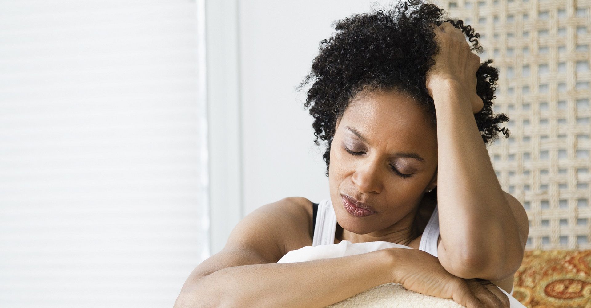 Stressed person sitting on bed