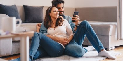 Couple sitting together on floor researching