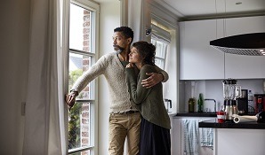 couple hugging and looking out the window