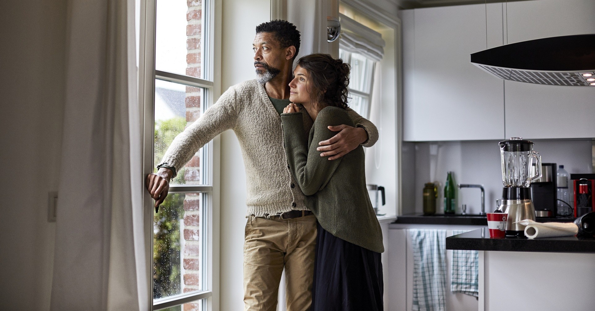 couple hugging and looking out the window