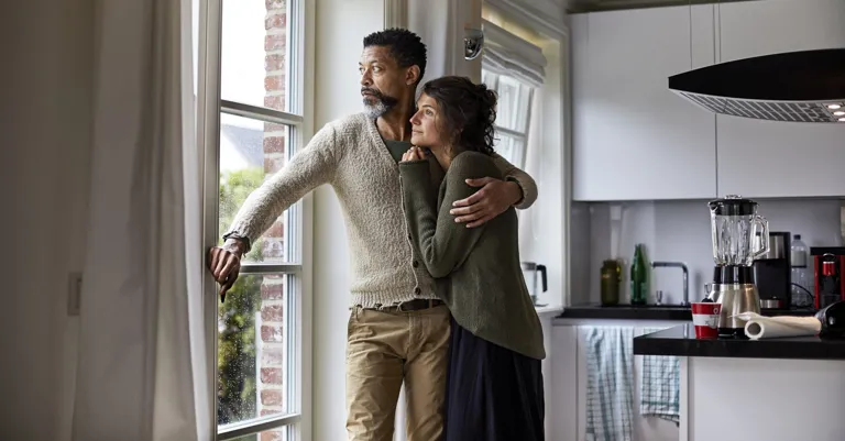couple hugging and looking out the window