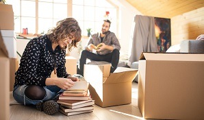 Couple packing moving boxes