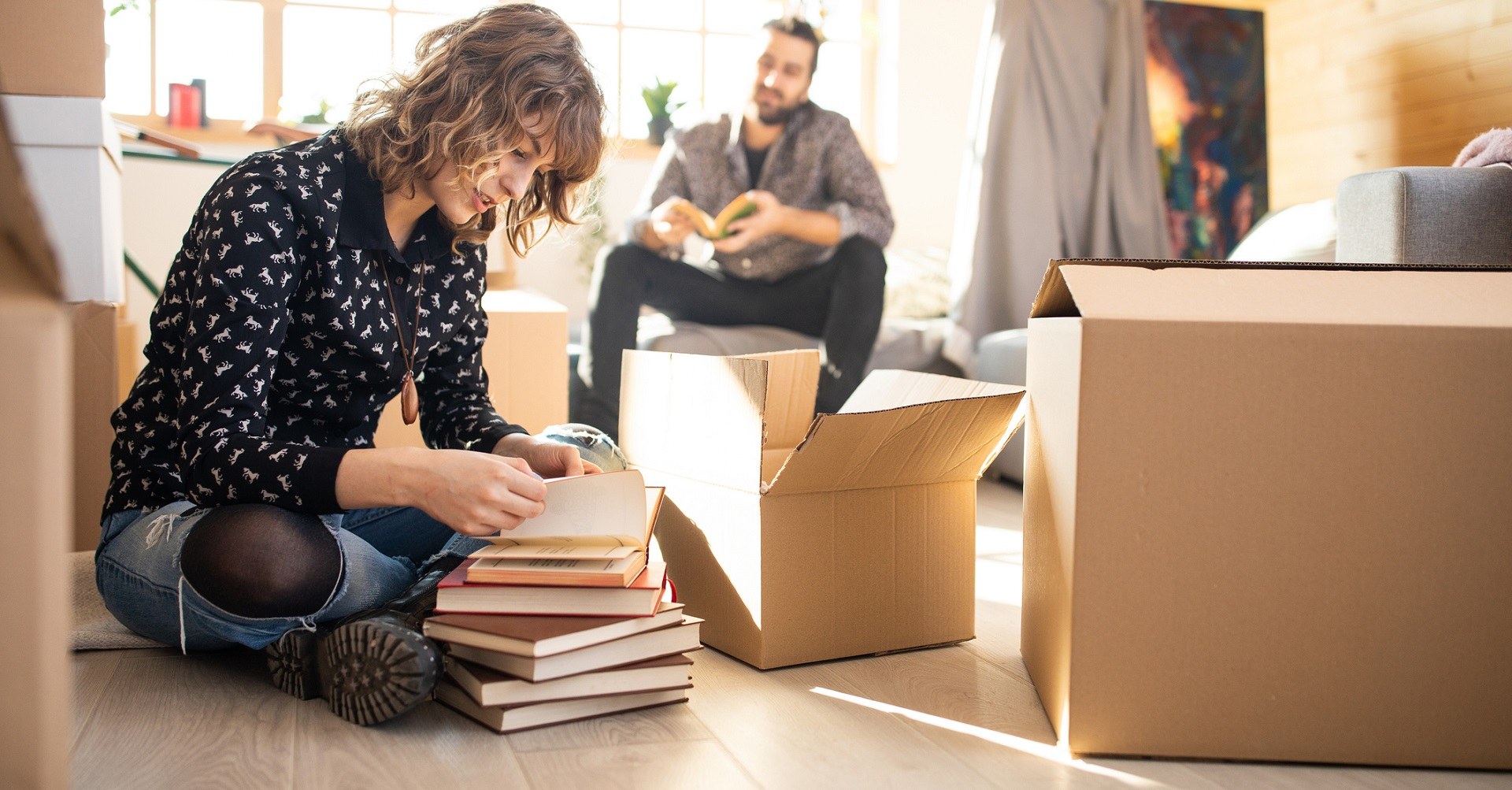 Couple packing moving boxes