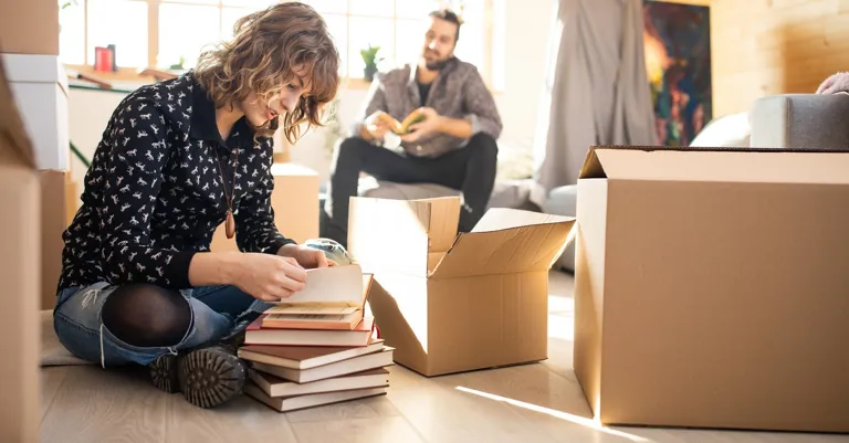 Couple packing moving boxes