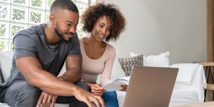man and woman using laptop