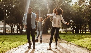 Parents playing with child in park