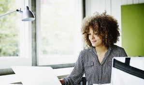 Businesswoman sitting at desk with laptop