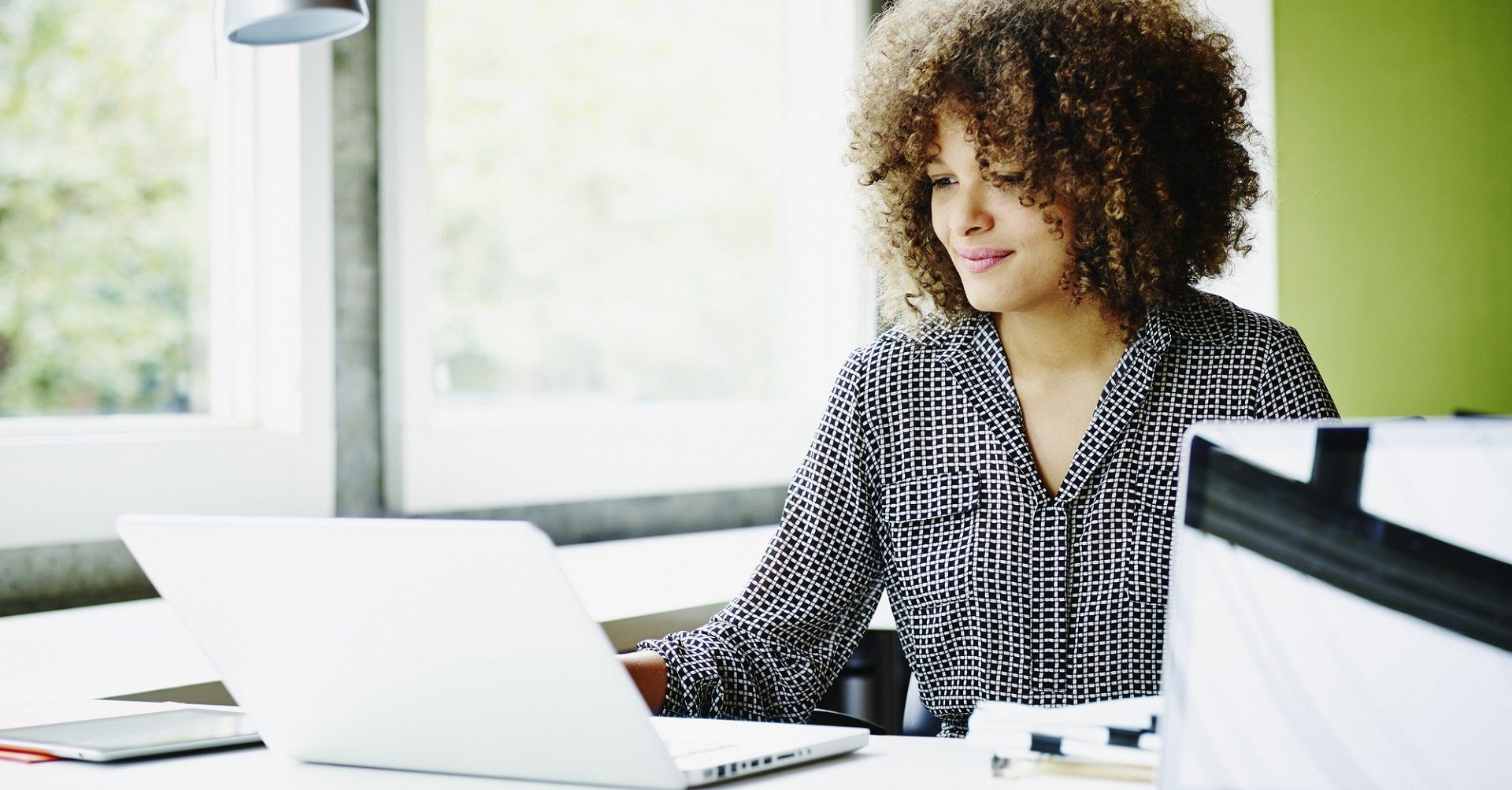 Businesswoman sitting at desk with laptop