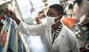 pharmacist getting medication for customer