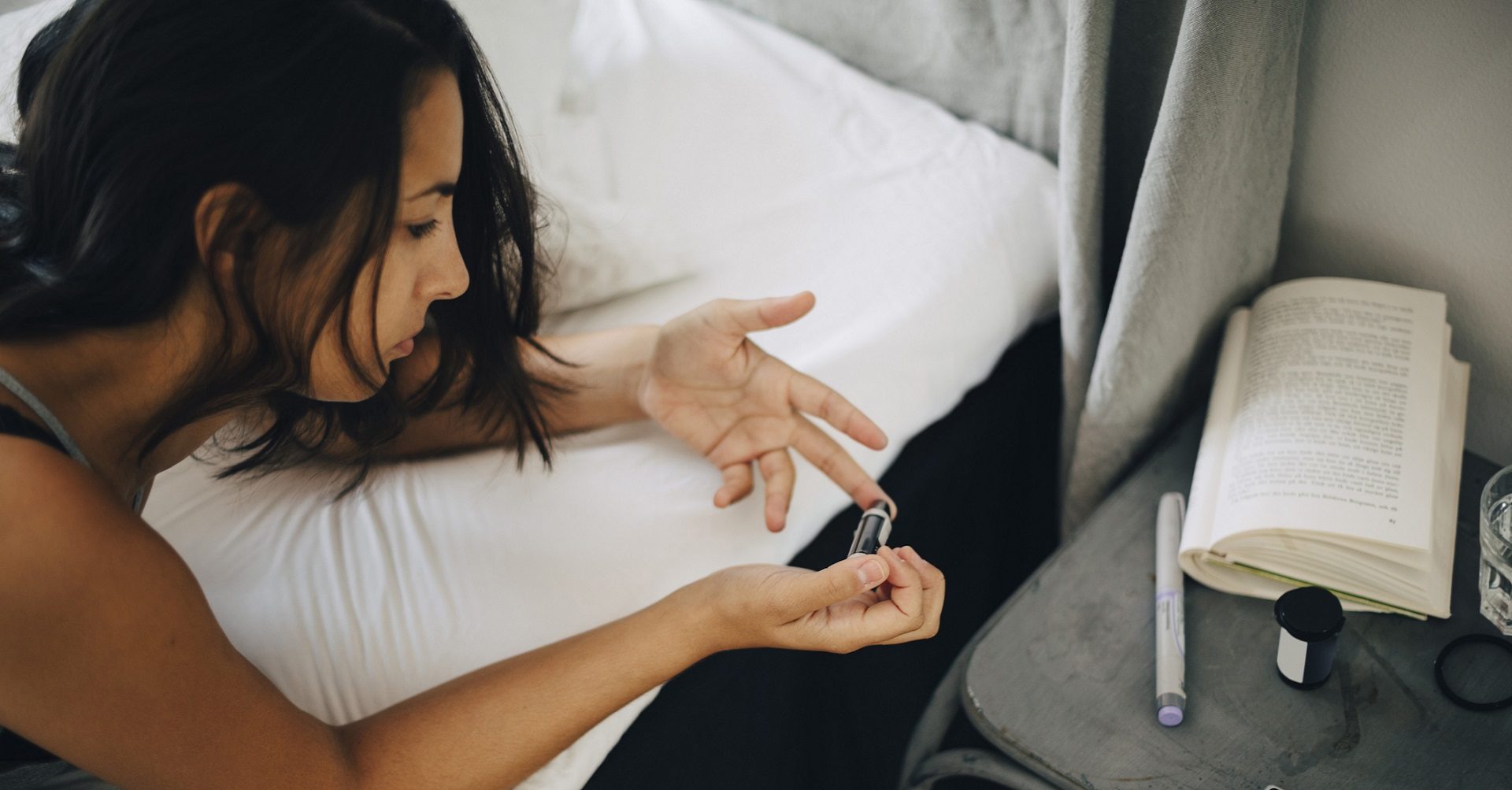 Woman taking blood sugar measurement