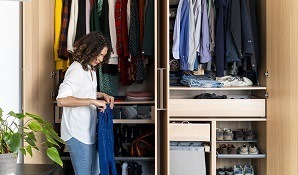 woman cleaning out her cupboard