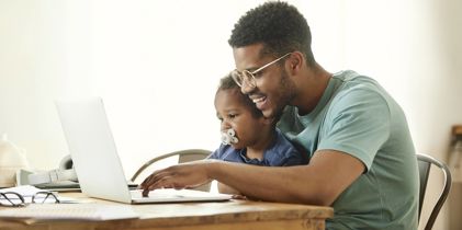 Father and son looking at a laptop