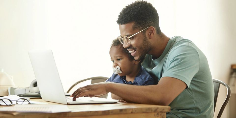 Father and son looking at a laptop