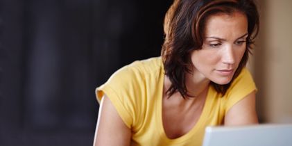 Woman looking at laptop concerned