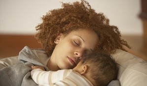 mother sleeping with baby on chest