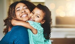 Mother hugging daughter