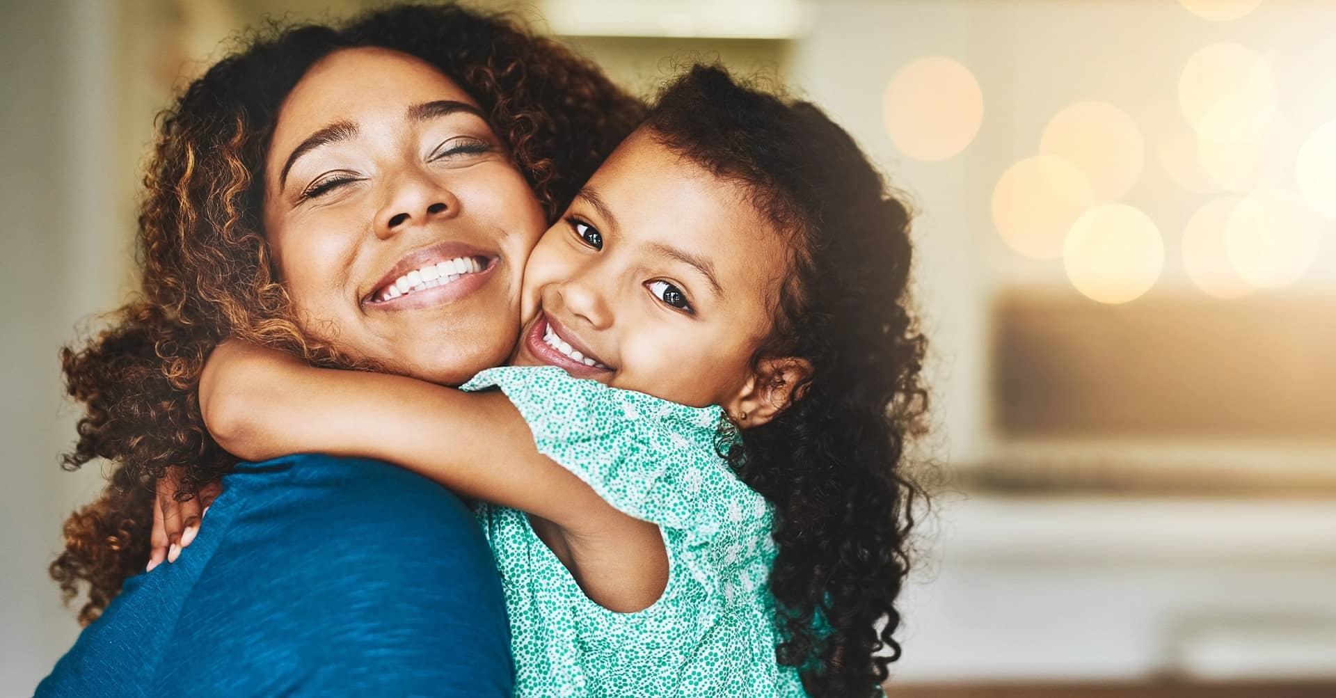 Mother hugging daughter