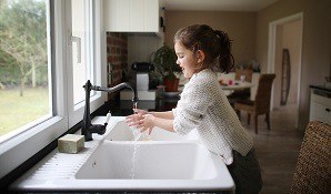 Little girl washing her hands