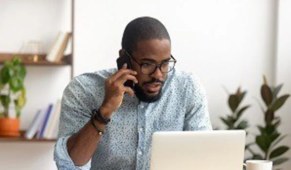 Man looking at laptop looking worried