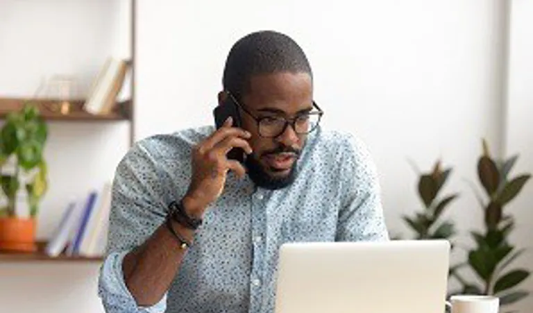 Man looking at laptop looking worried