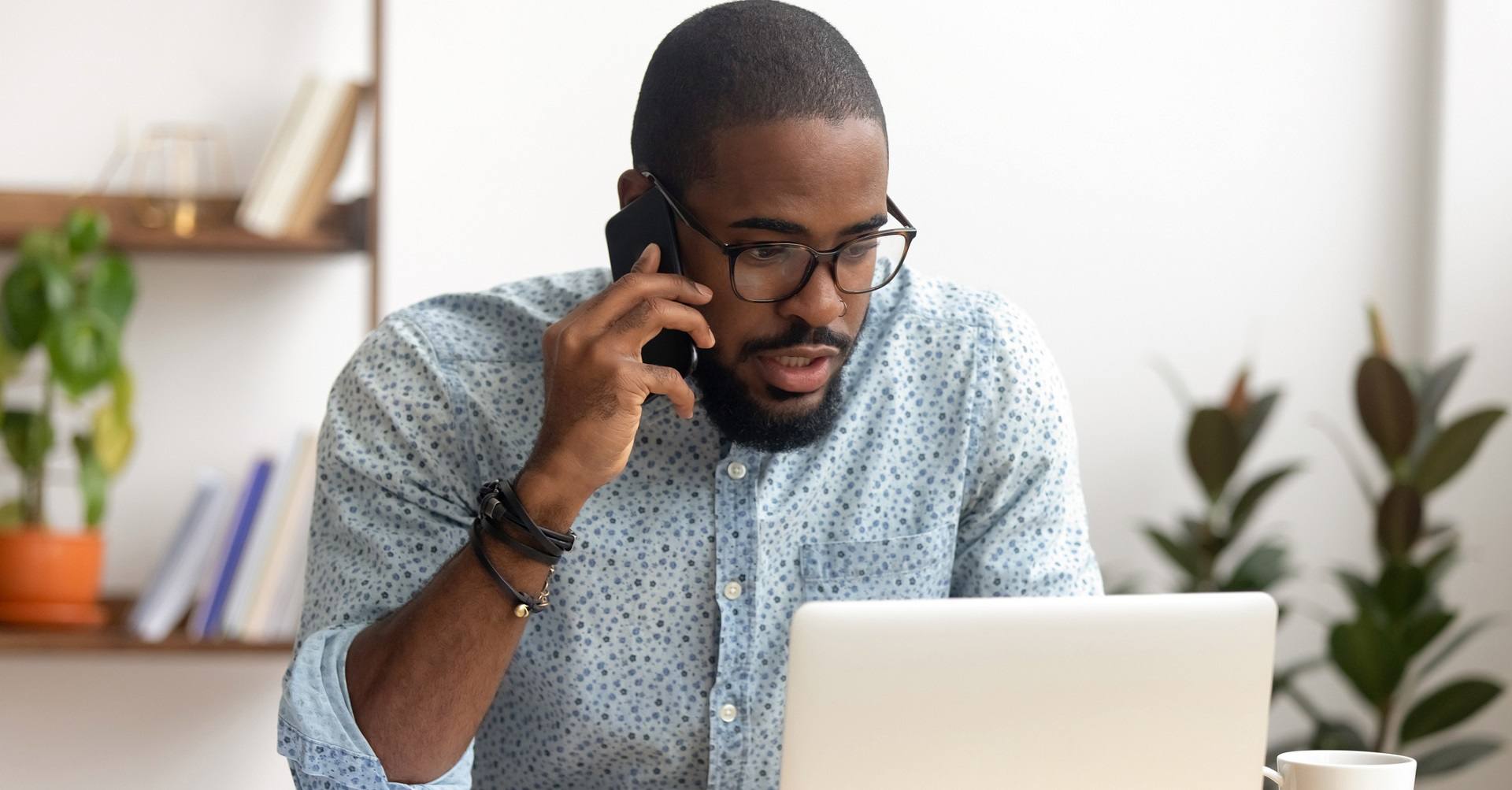 Man looking at laptop looking worried